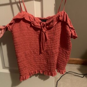 A peach colored woman’s tank top from American Eagle